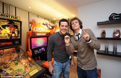 David Luis and Júlio César with our Indiana Jones Pinball and Grid Racing deluxe arcade games for hire