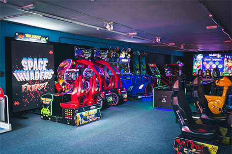 Kid playing a pinball machine in the home