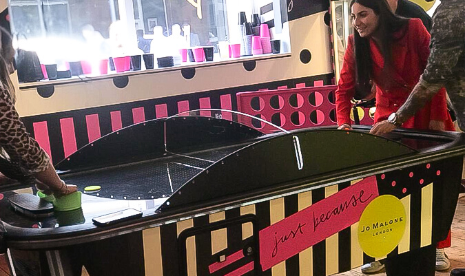 a custom branded air hockey table for Jo Malone