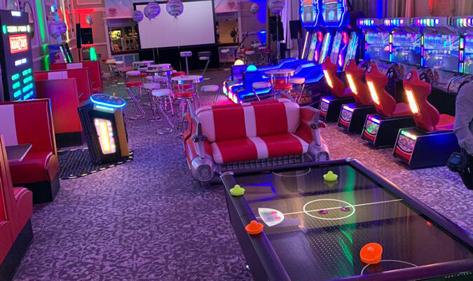 A large selection of arcade games in a hotel conference room