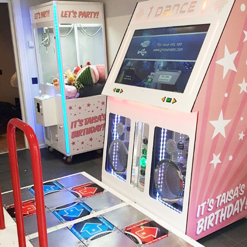 dance stage and claw machine at a kids birthday party